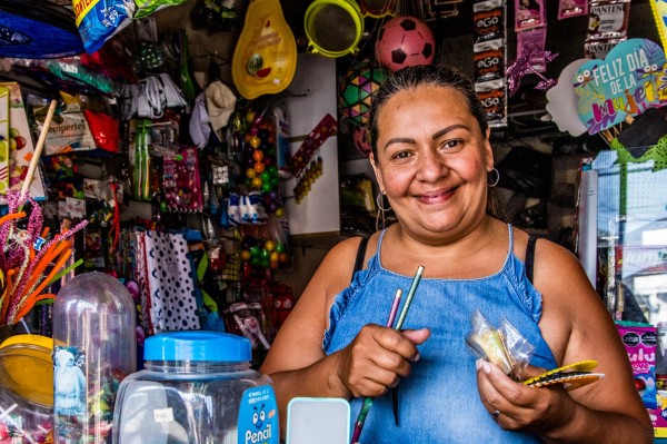 Jenny Andrea Tovar organising products in her shop in Colombia